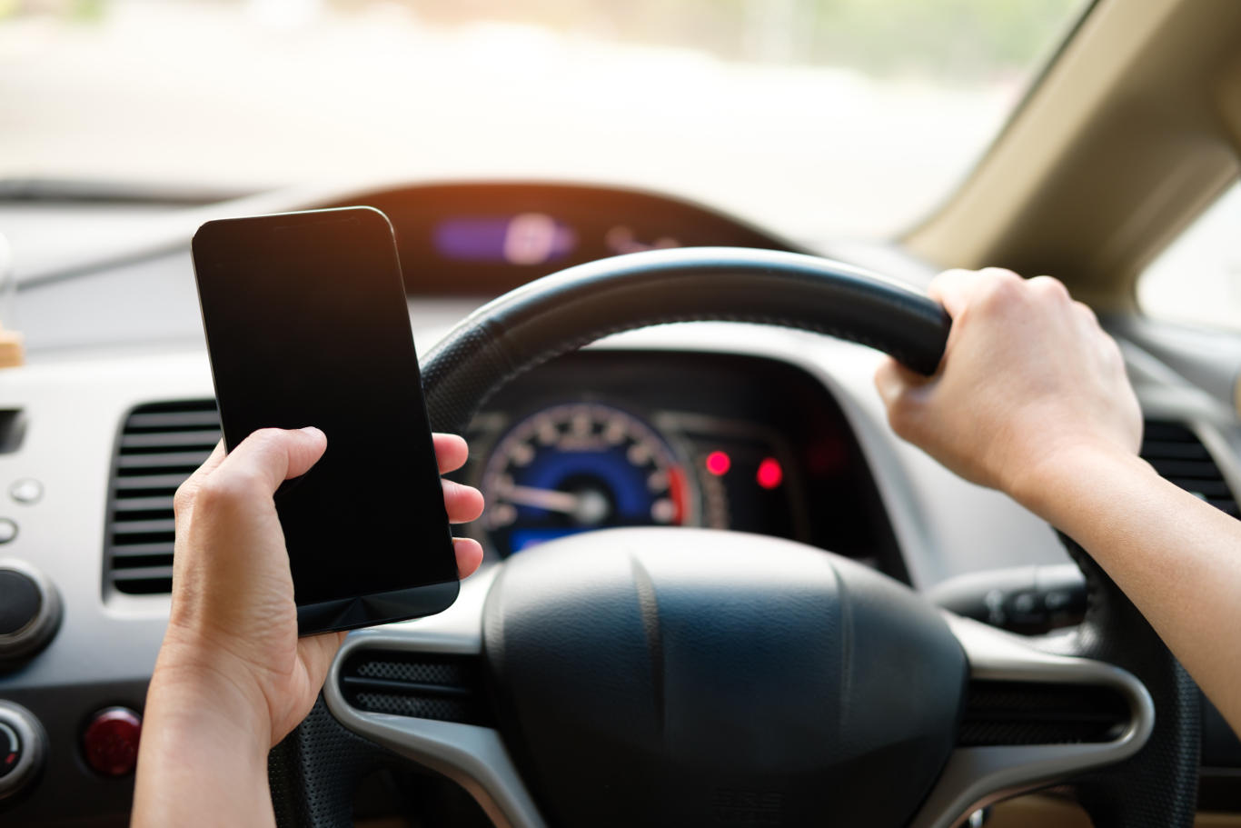 Using a GPS, looking at a smart watch, and even eating are also affected Man holding phone